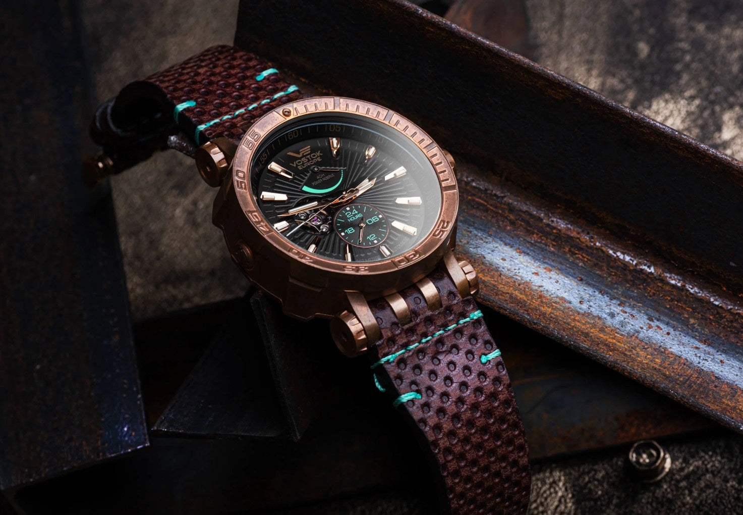 Close-up of the Vostok Europe Energia Bronze watch caseback with an engraved rocket illustration, 30 ATM water resistance markings and a brown leather strap with bronze fittings